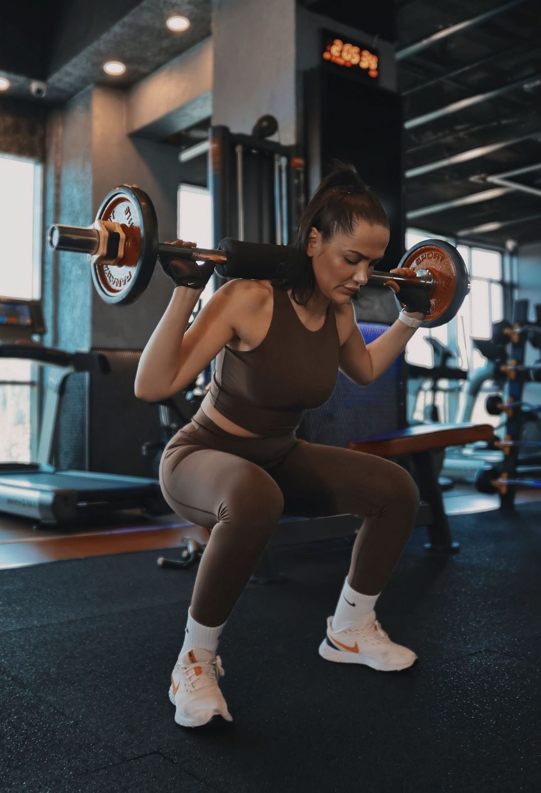 Footballer lifting weights in the gym during the season